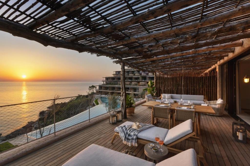 Six Senses Ibiza luxury resort sunset terrace with infinity pool views, outdoor dining and Mediterranean Sea panorama